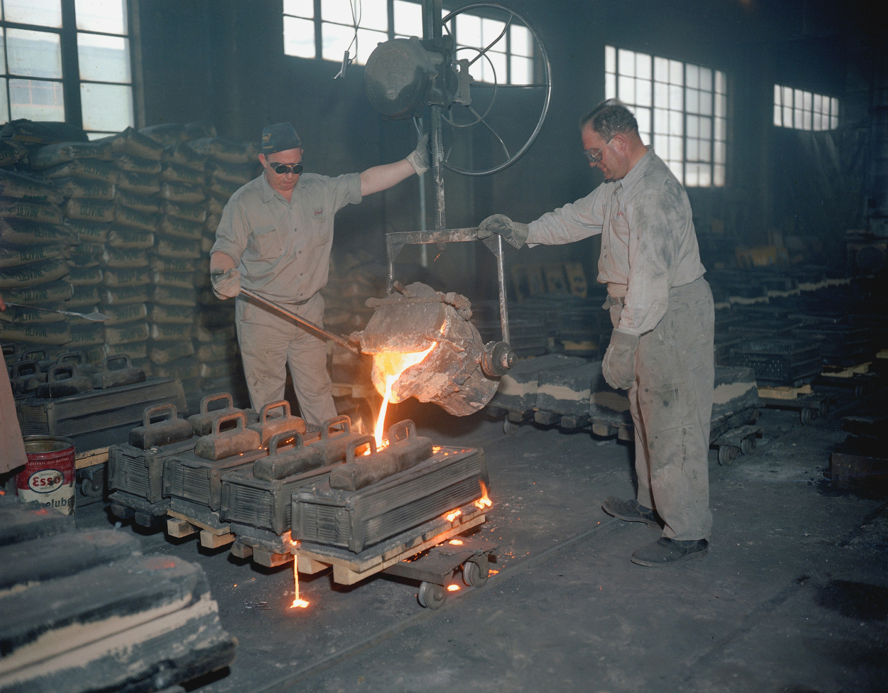 Foundry technicians working on a casting